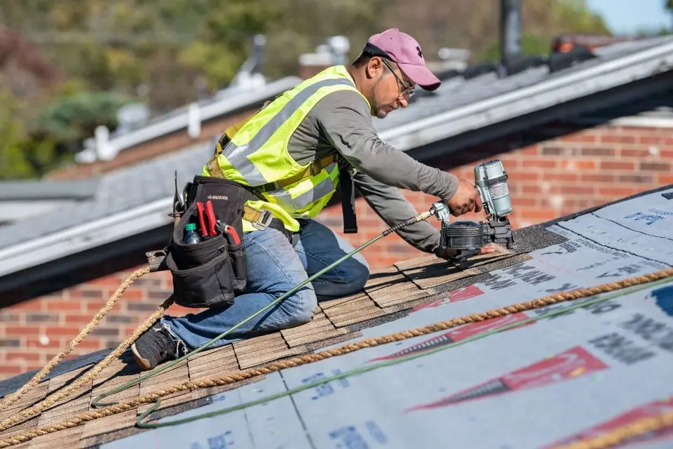 Rocket City Roofing Pros installer nailing architectural shingles on a Huntsville AL home